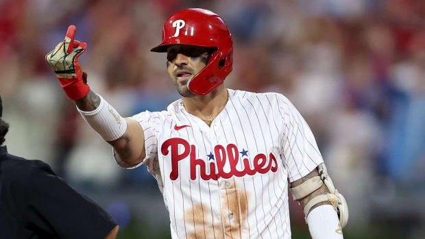 Phillies right fielder Nick Castellanos flashes his ring finger to teammates after hitting a double against the Marlins in the NL wild card series